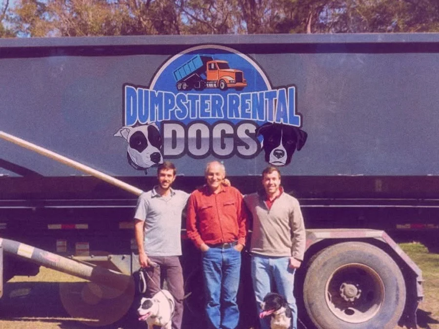 The Dumpster Rental Dogs team with their branded roll-off dumpster