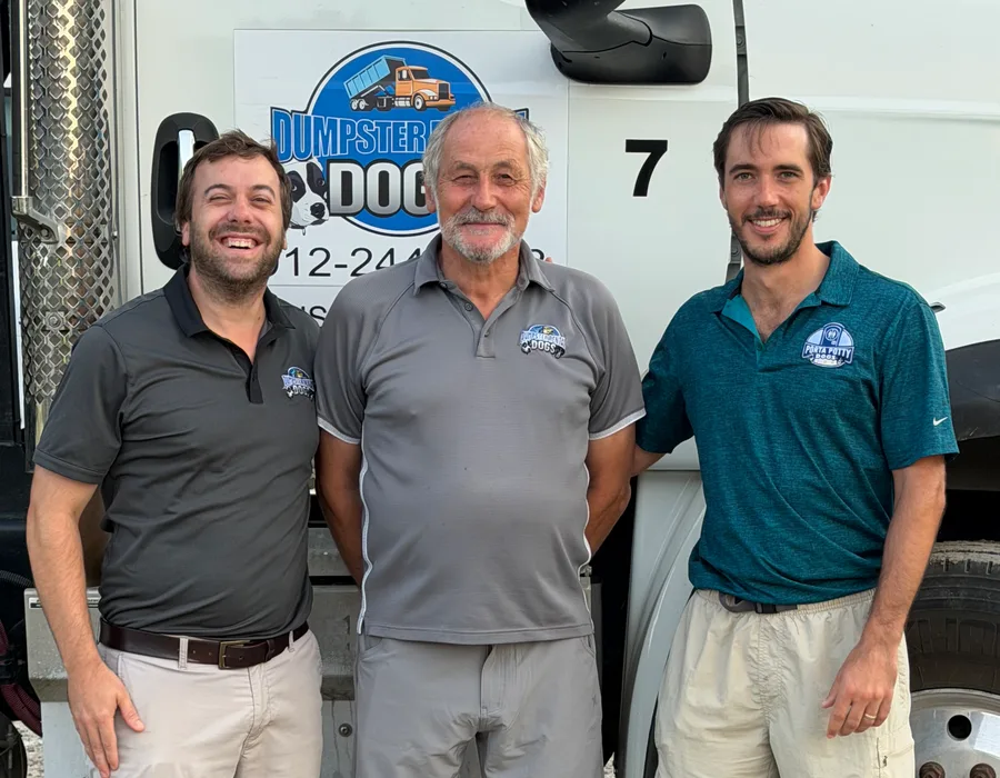 Founders Sean Dane-Kellogg, Jacky Lemaigre, and Max Lemaigre in front of a Dumpster Rental Dogs roll-off truck