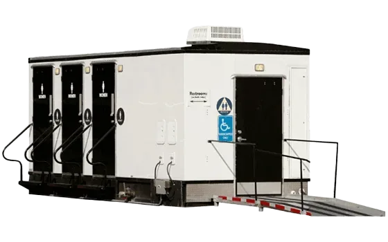 Portable VIP restroom trailer with three stalls and an accessible entrance ramp.